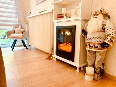 a fireplace in a living room with a mannequin next to it at Vanja in Čukarica