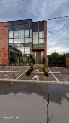 a large glass building with a star in a parking lot at Studio Pop Art in Batajnica