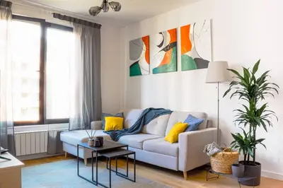 a living room with a couch and a table at Belgrade Riverfront Fortress Apartment in Belgrade