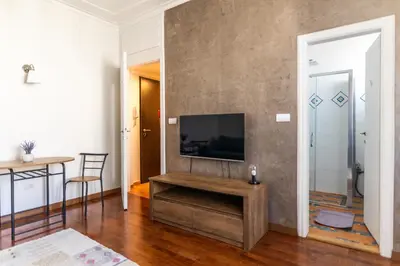 a living room with a flat screen tv on a wall at Ugi house - City Center in Belgrade