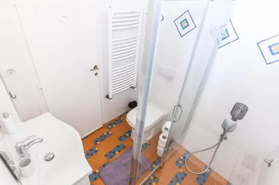 a small bathroom with a toilet and a sink at Ugi house - City Center in Belgrade