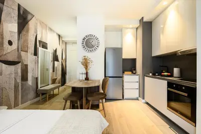 a kitchen with a table and a small table with chairs at inJoy in Belgrade