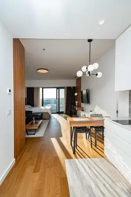 a kitchen and living room with a bed and a table at West 21 Tower in Fontana