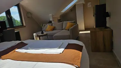 a bedroom with a bed and a living room at Soul River e cucina in Pančevo
