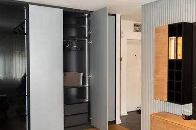 a room with a closet with black shelving at Royalux Kennedy Residences in Tošin Bunar