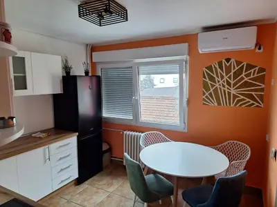 a kitchen with a table and chairs in a room at Temple saint sava in Dušanovac (historical)