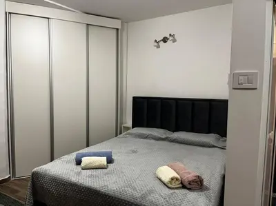 a bedroom with a bed with two towels on it at Squeeze The Day in Belgrade