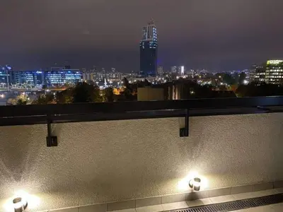 a city skyline at night with lights on a building at Skyline in Belgrade