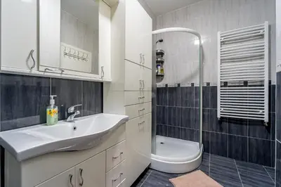 a white bathroom with a sink and a toilet at Apartment Urban Garden in Belgrade