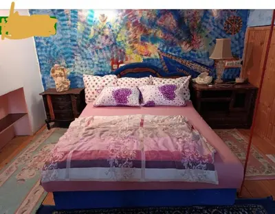 a bedroom with a bed with a painting on the wall at Maravilja in Filmski Grad