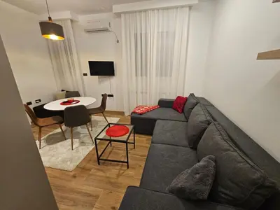 a living room with a couch and a table at Apartman Oki in Belgrade