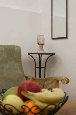 a bowl of fruit on a table next to a statue at Golden Velvet apartment Belgrade in Belgrade