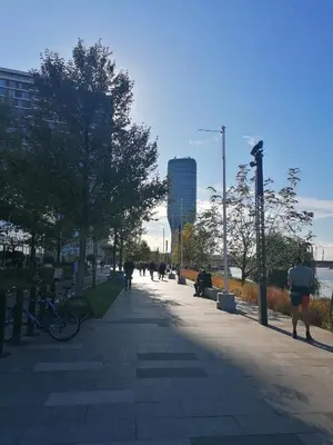people walking down a sidewalk in a city at Belgrade Waterfront Cozy Symphony 2 in Sajmište
