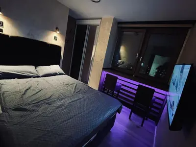 a bedroom with a bed and a purple light at Loronobeo.forest in Belgrade