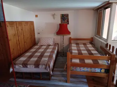 a bedroom with two beds and a red lamp at Maravilja 7 in Belgrade