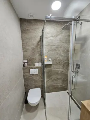 a bathroom with a toilet and a shower at Anchy in Belgrade