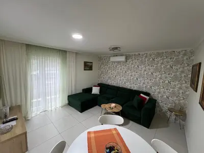 a living room with a green couch and a table at Paradiso1 in Vračar (historical)