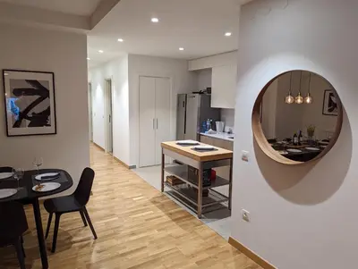 a kitchen and dining room with a table and a mirror at Belgrade Waterfront Victory Gardens in Sajmište