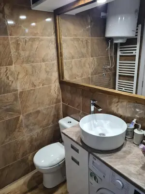 a bathroom with a sink and a toilet and a mirror at Blue apartman in Belgrade