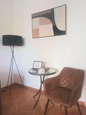 a table and a chair in a room at DukeStepa in Belgrade