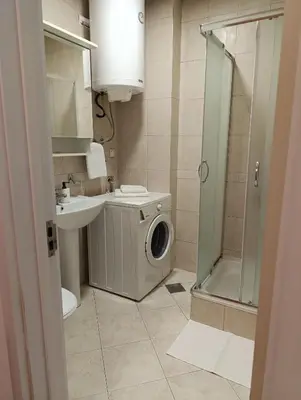 a bathroom with a washing machine and a sink at Kala in Belgrade