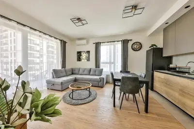 a living room with a couch and a table at Modern apartment on the Belgrade Waterfront in Belgrade