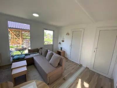 a living room with a couch and a table at Danube Oasis Stevantown 1 in Stari Banovci