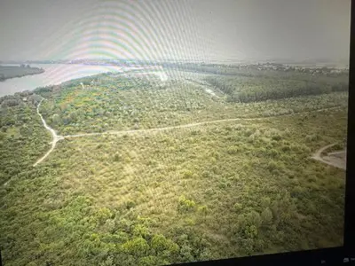an aerial view of a forested area with a rainbow at Danube Oasis Stevantown 3 in Stari Banovci