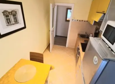 a small kitchen with a table and a counter top at Magistar in Zemun
