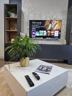 a white coffee table with two remote controls on it at ARTA LUX - Galerija Beograd na vodi - Belgrade Waterfront in Belgrade
