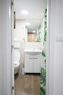 a bathroom with a white sink and a toilet at Smestaj Centar Ub 35 in Ub
