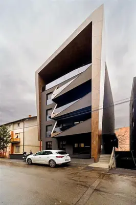 a white car parked in front of a building at Dark Nest 2 Belgrade Apartments in Belgrade