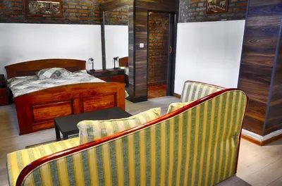 a bedroom with a bed and two chairs and a table at Studio 600 in Belgrade