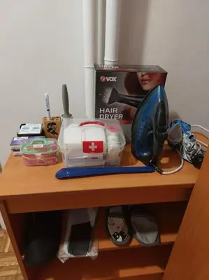 a table with a hair dryer and other items on it at Toni apartments in Voždovac