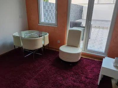 a dining room with a glass table and two chairs at Apartment Stevanovic Belgrade in Vračar (historical)