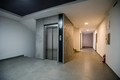 a hallway of an office building with a door at TOP VIEW apartment 47 in Arandjelovac