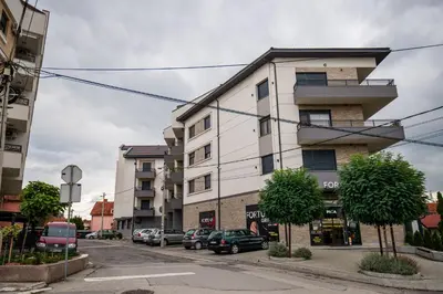 an apartment building on a street with parked cars at TOP VIEW apartment 40 in Arandjelovac