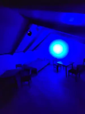 a blue room with chairs and a table in it at Pool House 365 in Pe°ani