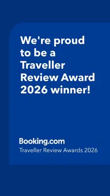 a blue sign that says were proud to be a traveller reviewagency winner at Amare in Inđija