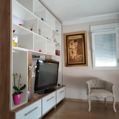a living room with a tv and a chair at Kutak na Lekinom brdu in Vračar (historical)