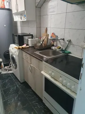 a kitchen with a sink and a washing machine at Small cute single room A2 in Pancevo in Pančevo