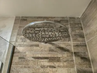 a bathroom with a metal toilet in the floor at Apartman Bika in Surčin