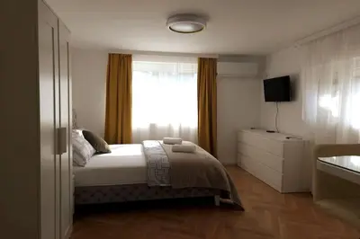 a bedroom with a bed and a window at Airport Studio Stefan in Belgrade