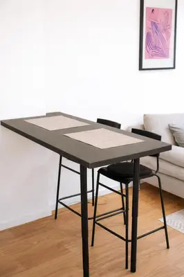 a black table and two chairs in a living room at Aura Apartment - Lovely Apartment with Garage Parking in Belgrade