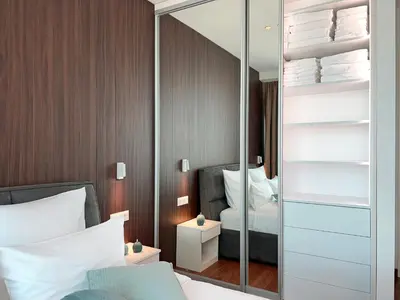 a bedroom with a mirror and a bed at Premium Simfonija Apartment in Belgrade