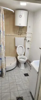 a bathroom with a toilet and a tub and a sink at Kristian in Belgrade