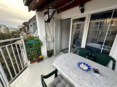 a table and chairs on the balcony of a house at Sky Rooftop Huge Apartment in Belgrade
