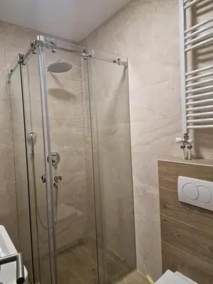 a shower with a glass door in a bathroom at Lux apartman 2 Ledine in Ledine
