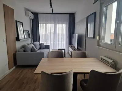 a living room with a table and a couch at Lux apartman 2 Ledine in Ledine