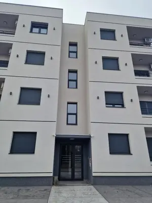a building with a door in front of it at Lux apartman 2 Ledine in Ledine